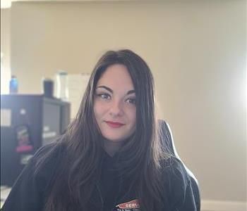 Woman with dark hair and smiling with SERVPRO shirt