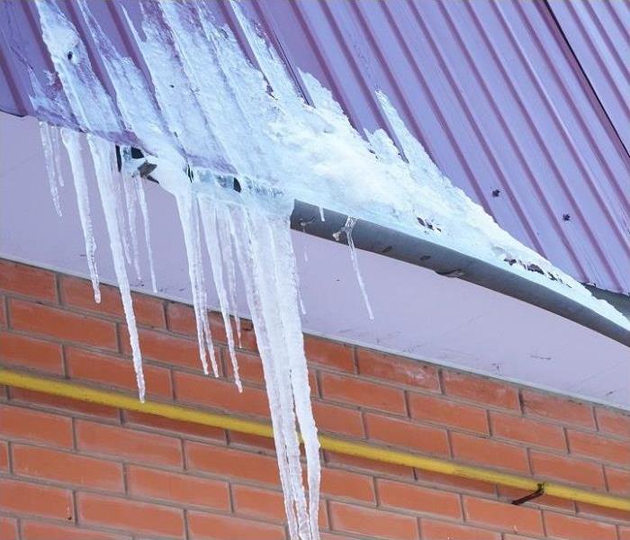 ice in gutter and snow on roof