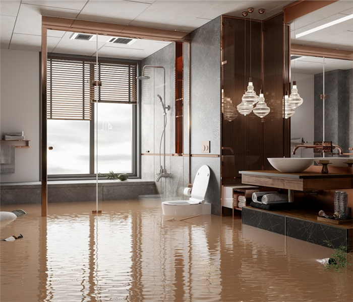 a flooded bathroom with water everywhere and furniture floating around