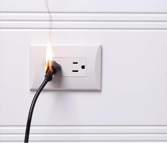 cord plugged into outlet, cord is burning