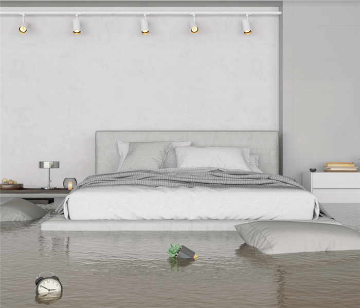a flooded bedroom with water everywhere and items floating around